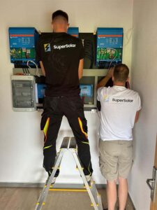 Technician installing solar power system components.