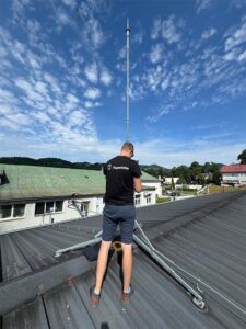 Technician installing lightning rod.