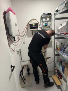 Technician installing solar power system components.