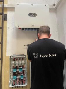 Technician installing solar power system components.